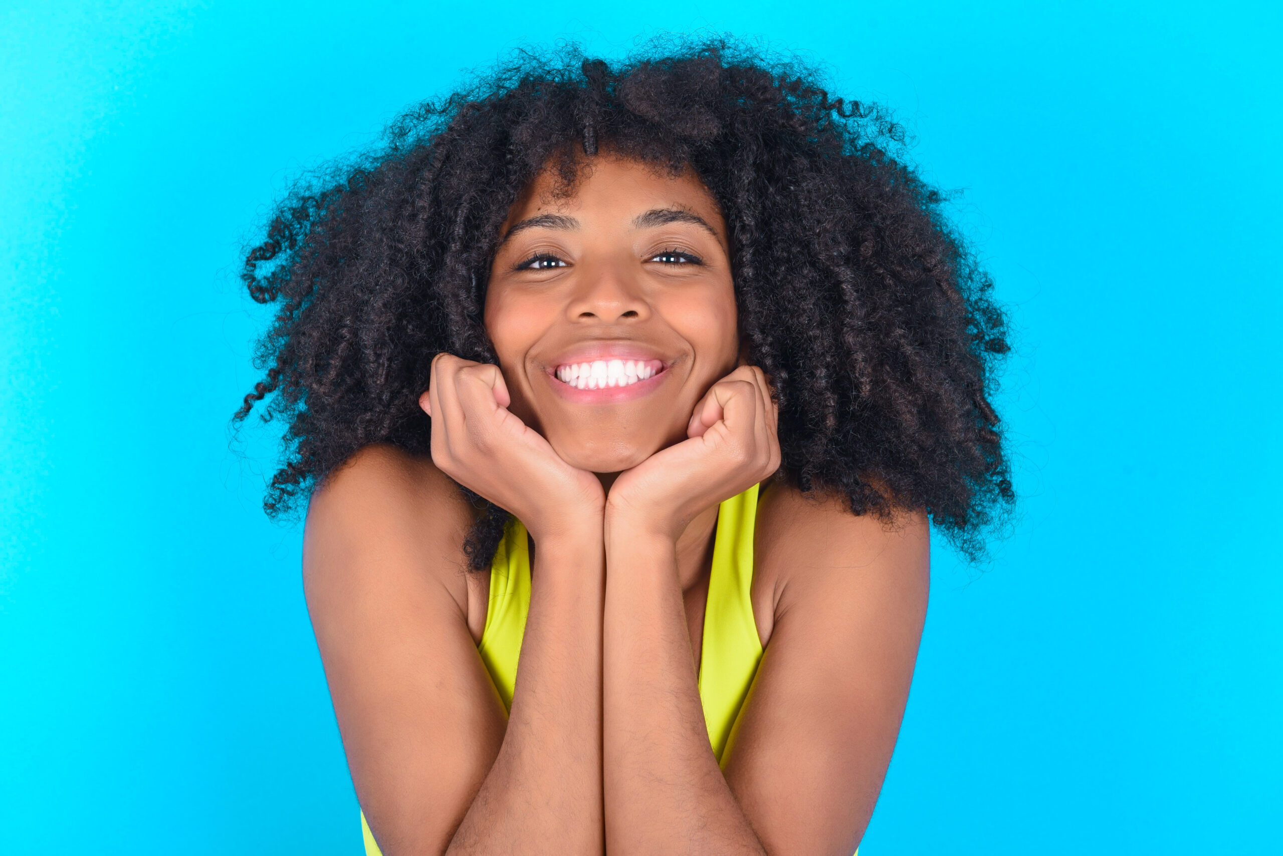 Happy expression, has toothy smile.